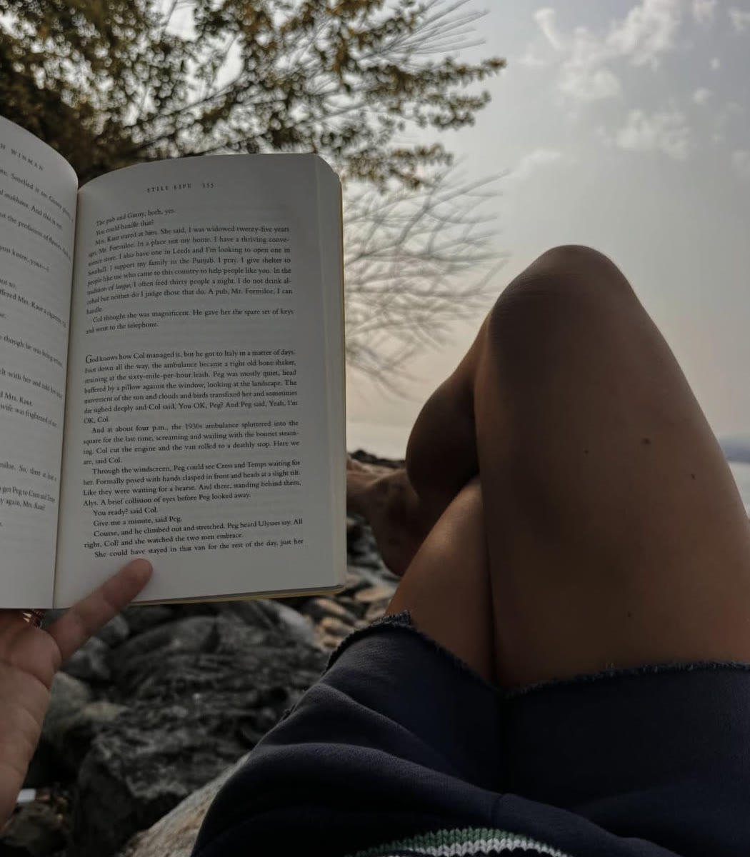 A quiet moment reading by the water